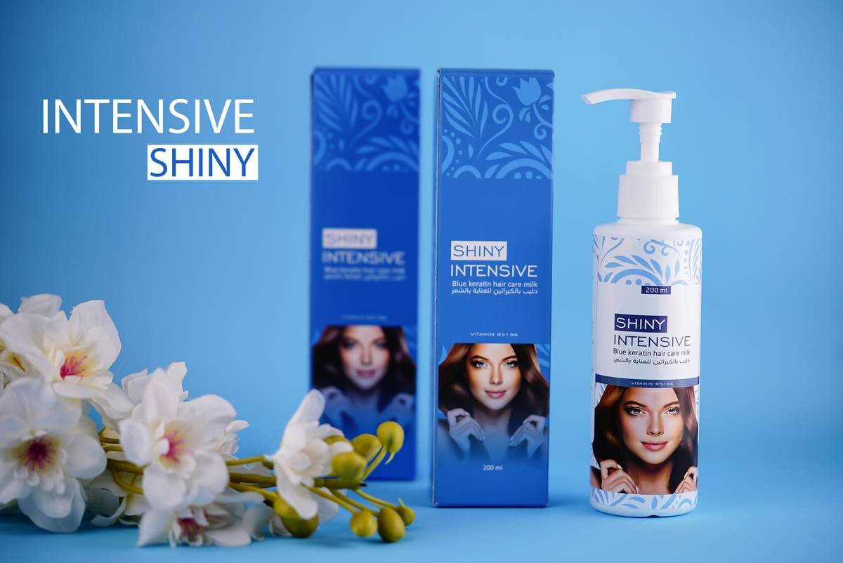 Woman applying hair nourishing gel to damp curls for definition and hydration