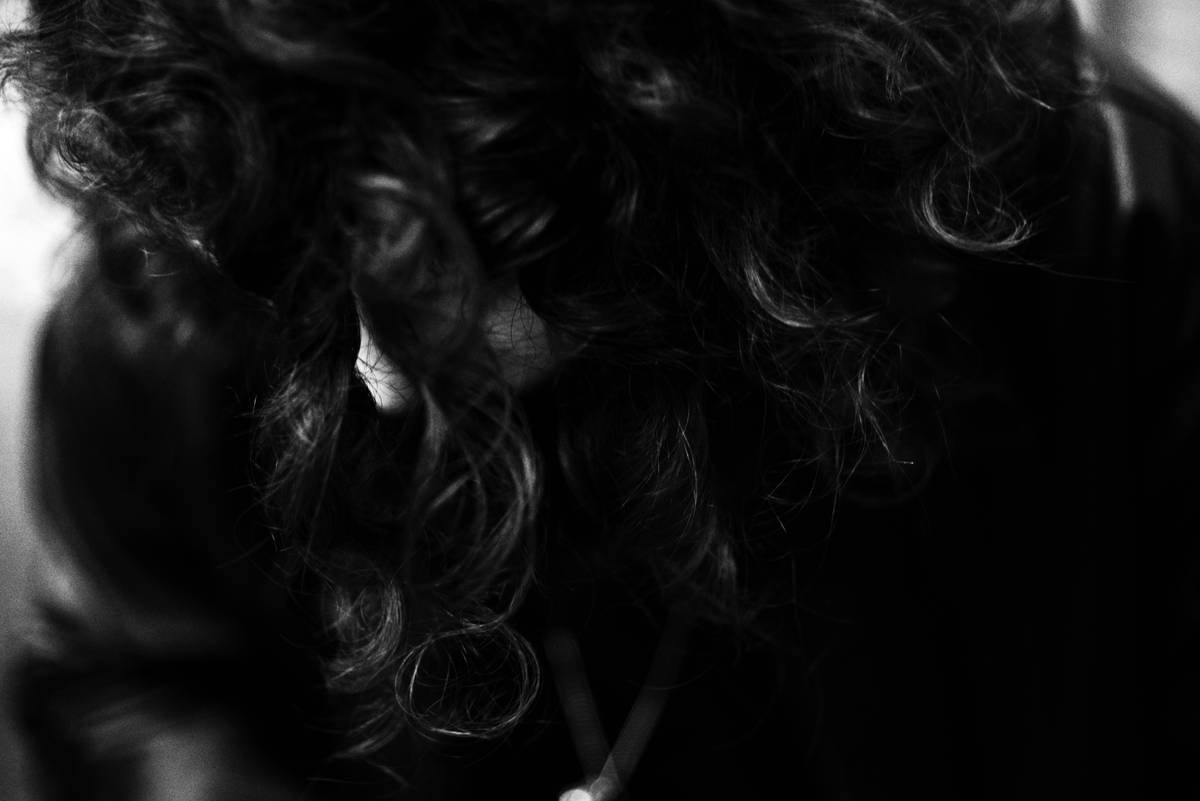 Man applying styling balm to damp hair for natural texture